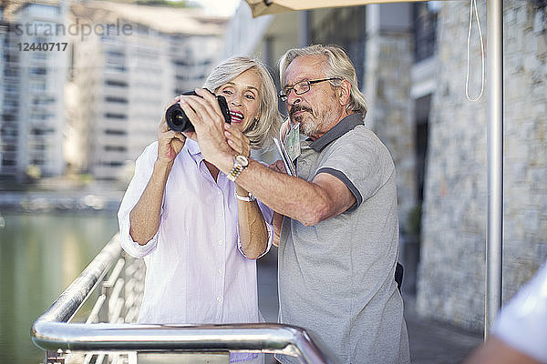 Senior couple taking a city break  taking photos