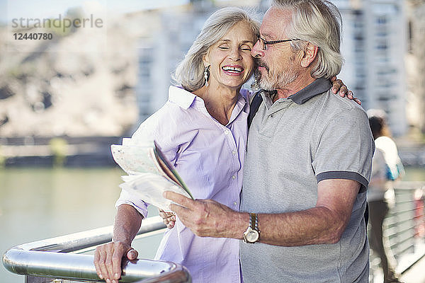 Senior couple taking a city break  holding map