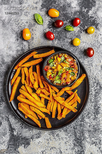 Homemade sweet potato fries and bowl of tomato basil dip