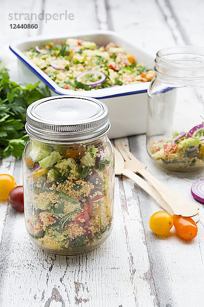 Preserving jar of Couscous salad with tomatoes  cucumber  parsley and mint