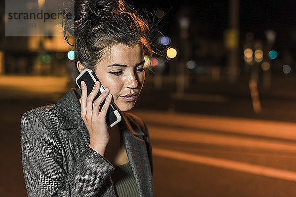 Young woman on the phone at night