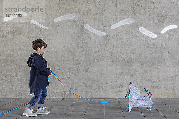 Little boy with origami dog