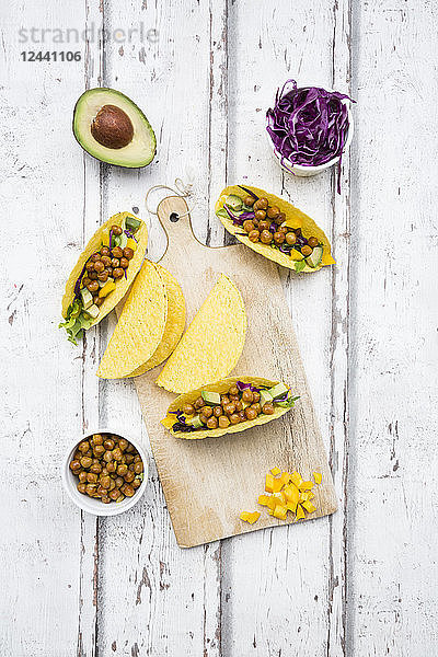 Vegetarian tacos filled with in curcuma roasted chick peas  yellow paprika  avocado  salad and red cabbage