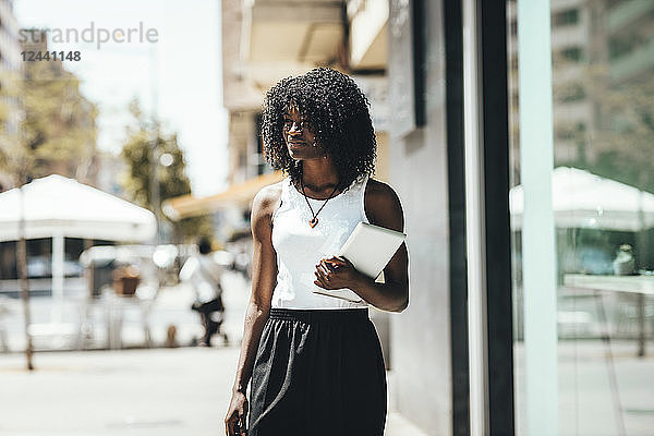 Woman with tablet in the city