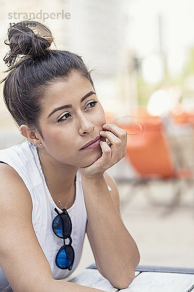 Portrait of Pensive young woman with bun