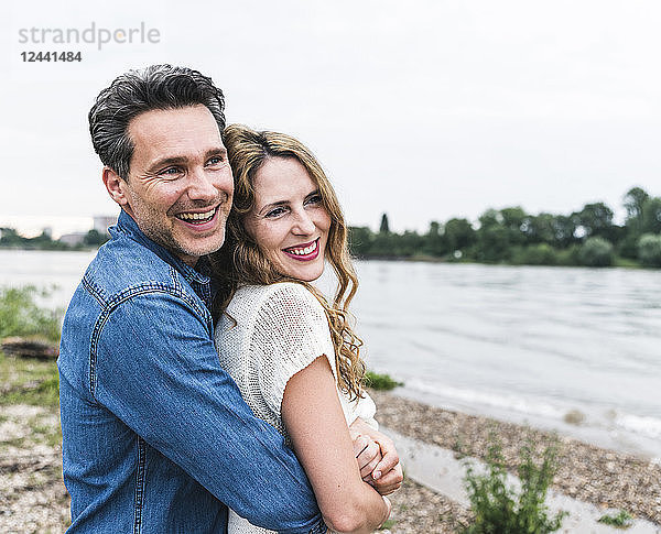 Happy affectionate couple at the riverside