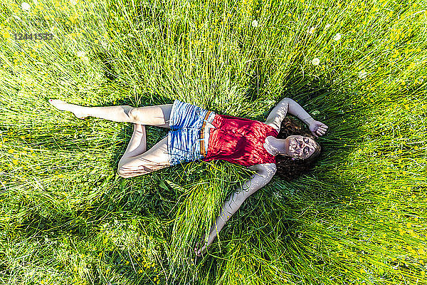 Young woman relaxing in meadow