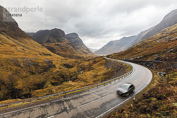 UK  Scotland  scenic road through the mountains in the Scottish highlands near Glencoe with a view on the Three Sisters
