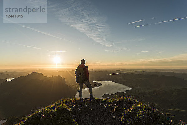 Austria  Salzkammergut  Hiker standing on summit  looking at view