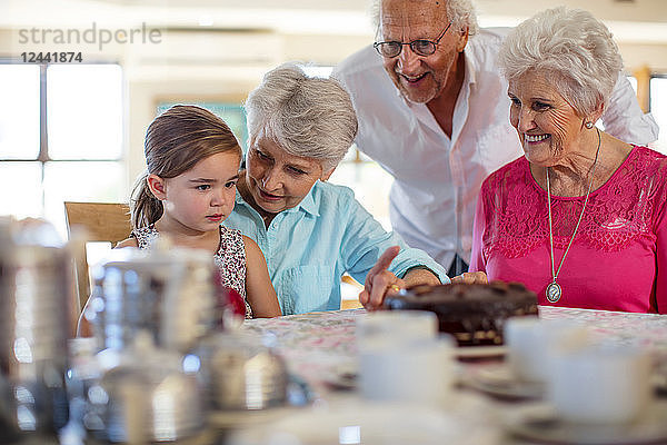 Grandparents celebrating a birthday with their granddaughter
