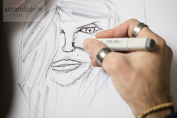 Close-up of artist drawing a sketch