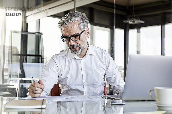 Businessman working at desk in office