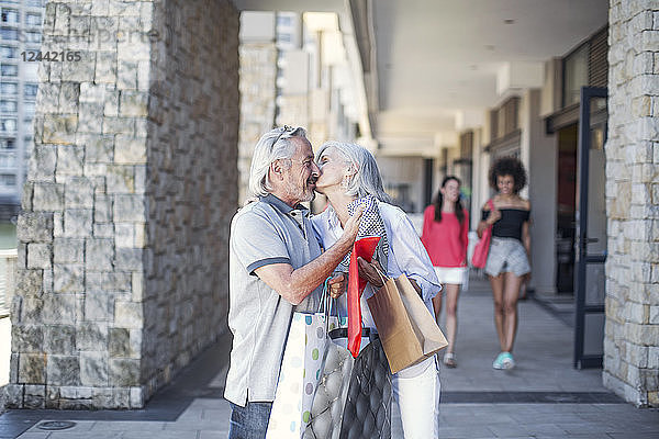 Senior couple taking a city break  going on a shopping spree