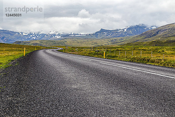 Die offene Landstraße führt in die Berglandschaft im Westen Islands  Island