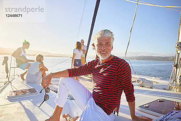 Portrait smiling man relaxing on sunny boat