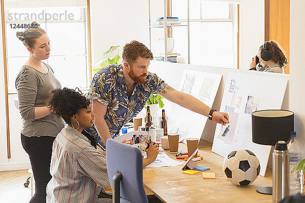 Creative designers reviewing story board proofs in office