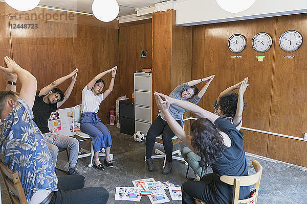 Creative business people stretching  taking a break in meeting