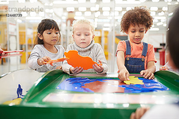 Kids playing at interactive exhibit in science center