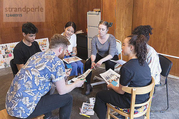 Creative designers reviewing proofs in office meeting