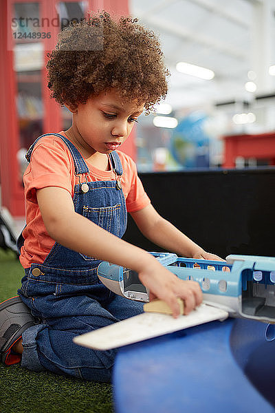 Curious girl playing in science center