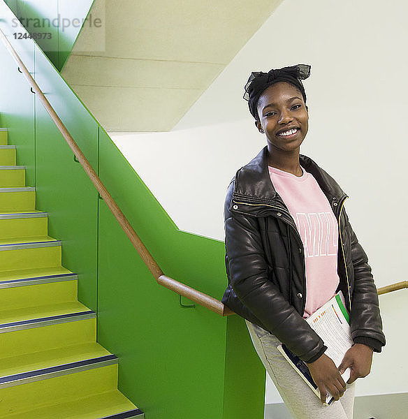 Portrait smiling  confident high school girl in stairway