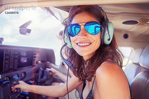 Portrait smiling  confident young woman flying airplane