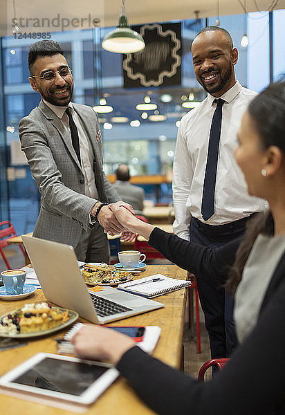 Business people handshaking  working in cafe