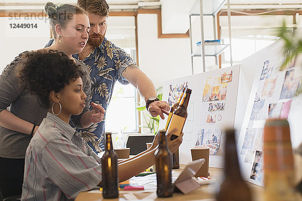 Creative designers people designing bottle label in office