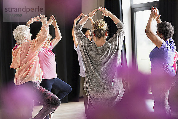 Active seniors exercising in circle