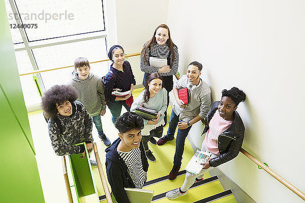 Portrait confident high school students on stair landing