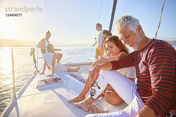 Friends relaxing on sunny catamaran