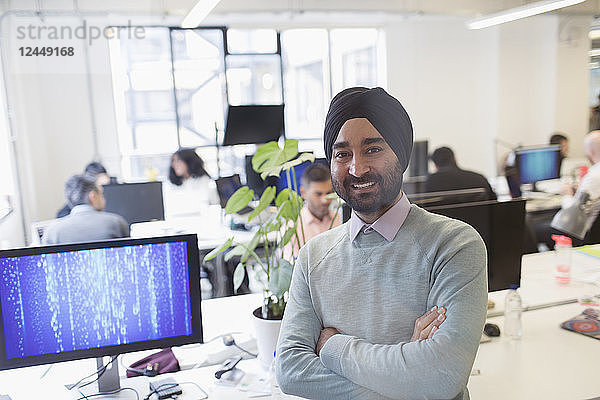 Portrait smiling  confident Indian computer programmer in turban in office