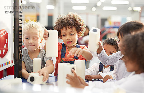 Kids playing with large dice in science center