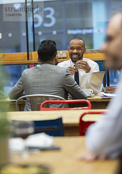 Businessmen talking  working in cafe