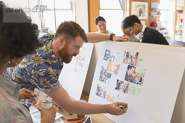 Creative designers reviewing story board proofs in office