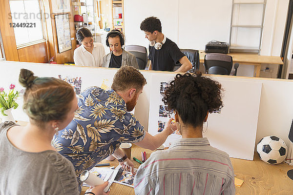 Creative designers reviewing story board in office