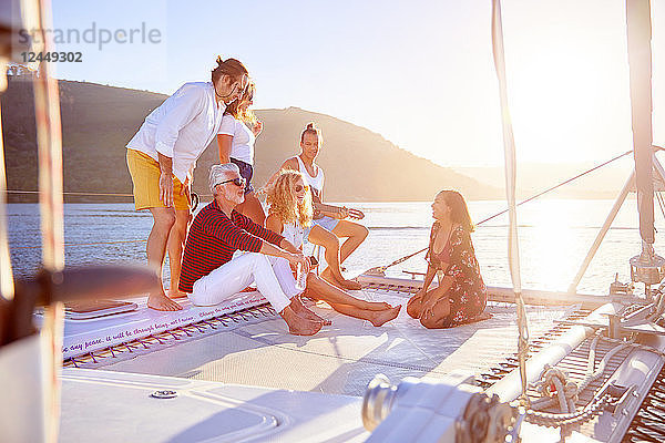 Friends relaxing on sunny catamaran