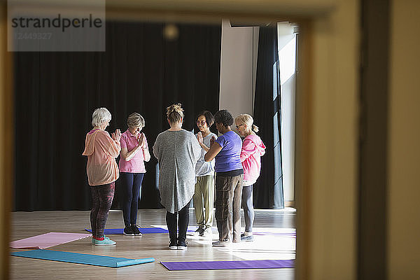 Serene active seniors practicing yoga in circle