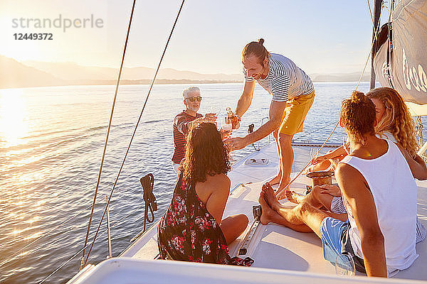 Friends relaxing  drinking champagne on sunny boat