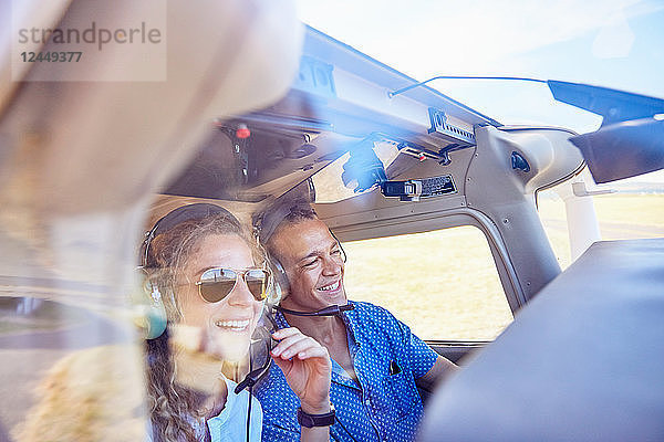 Happy pilot and copilot couple flying airplane