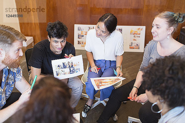 Creative designers discussing proofs in office meeting