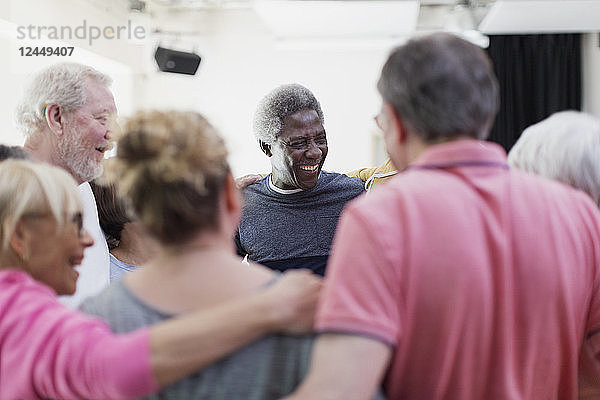 Active seniors forming circle huddle