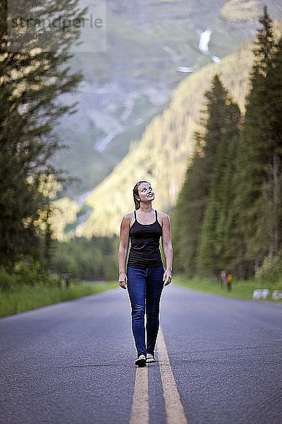 Eine Frau geht entlang der Going To the Sun Road im Glacier National Park  Montana