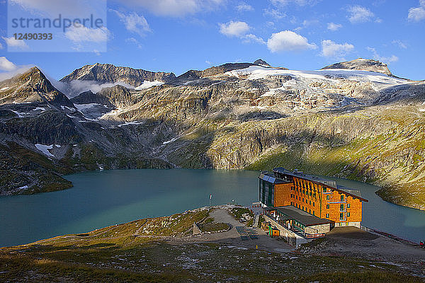 Die Rudolfshütte mit dem Weisssee  eine der Hütten  in denen Wanderer während der Glocknerrunde  einer 7-Etappen-Wanderung von Kaprun nach Kals rund um den Grossglockner  den höchsten Berg Österreichs  übernachten. Im Herzen des Nationalparks Hohe Tauern gelegen  der eine beeindruckende  gletscherbedeckte Hochgebirgslandschaft mit einer seit Jahrhunderten sorgsam gepflegten alpinen Kulturlandschaft kontrastiert  bietet die Glocknerrunde ein einzigartiges Natur- und Wandererlebnis. Am Ende einer jeden Tageswanderung laden Schutzhütten oder Berggasthöfe zum Rasten  Essen und Schlafen ein. Die Berghütten sind nur mit dem Nötigsten ausgestattet und bewirtschaftet  da die Versorgung und die Entsorgung von Abfällen aufgrund der Höhe  des extremen Klimas und der oft langen Aufstiege schwierig ist! Nach jeder Etappe haben Sie die Möglichkeit  die Glocknerrunde zu verlassen und in die Nationalparkorte Kaprun  Uttendorf  Kals  Heiligenblut oder Fusch abzusteigen  um dort in einer Pension  einem Gasthof oder einem Hotel zu übernachten. Die Tour führt überwiegend durch hochalpines Gelände  kann aber von jedem mit etwas alpiner Erfahrung und entsprechender Kondition und Ausrüstung bewältigt werden  da es keine Gletscher oder Abseilstellen auf der Strecke gibt. Schwindelfreiheit und Trittsicherheit sind erforderlich.'