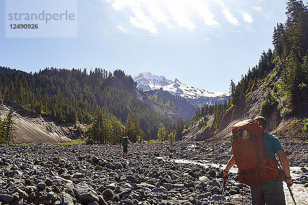 Wanderer auf dem Timberline Trail blicken flussaufwärts auf den Mount Hood