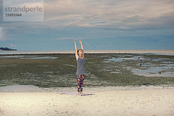 Eine Frau macht Yoga am Strand  Sonnenaufgang Zeit Indonesien-Gili Insel