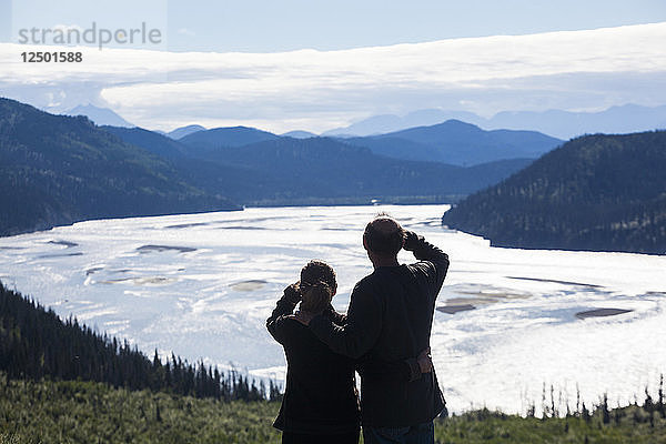 Ein Mann und eine Frau blicken auf das Flusstal des Chitina River in der Nähe von Chitina  Alaska.