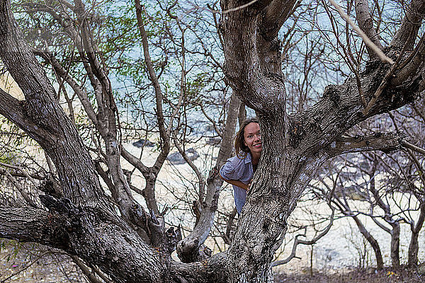 Yong Frau auf dem Baum.West Sumbawa.Indonesien.