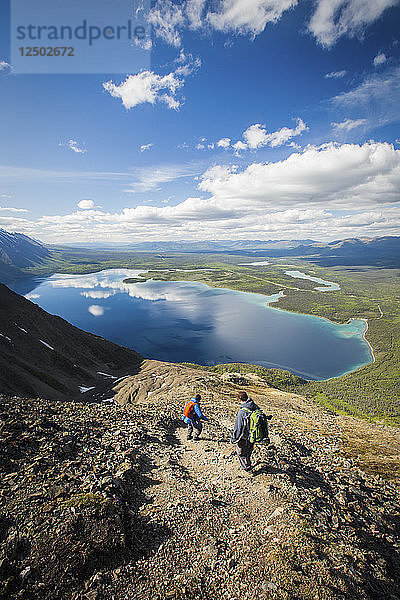 Zwei Wanderer rutschen die felsige Landschaft über dem Kathleen Lake in Yukon hinunter
