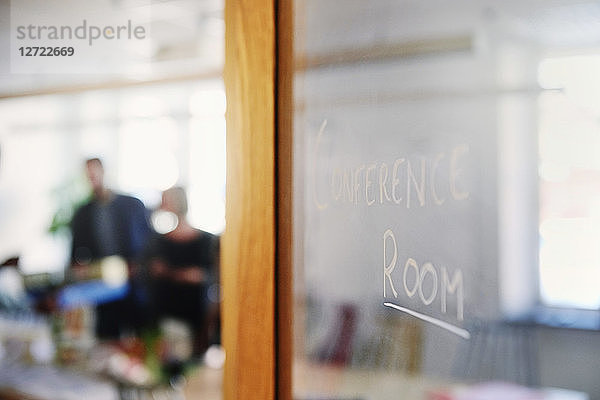 Conference room text on glass door in office